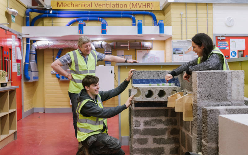 Construction student speaking to two tutors